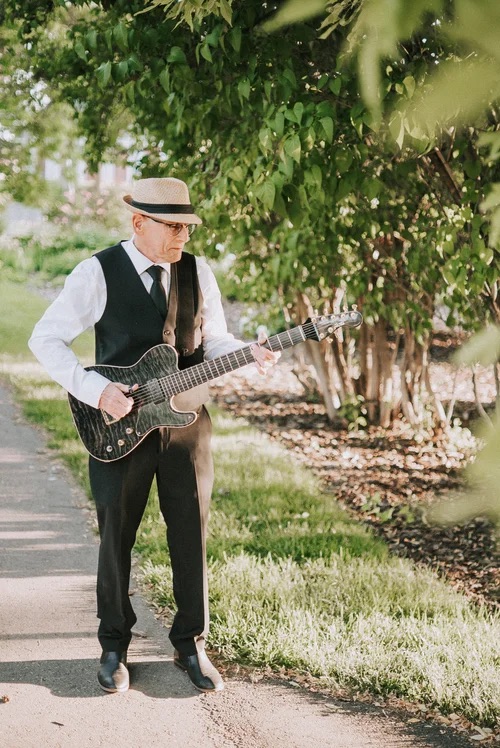 David Hirschman playing guitar outdoors